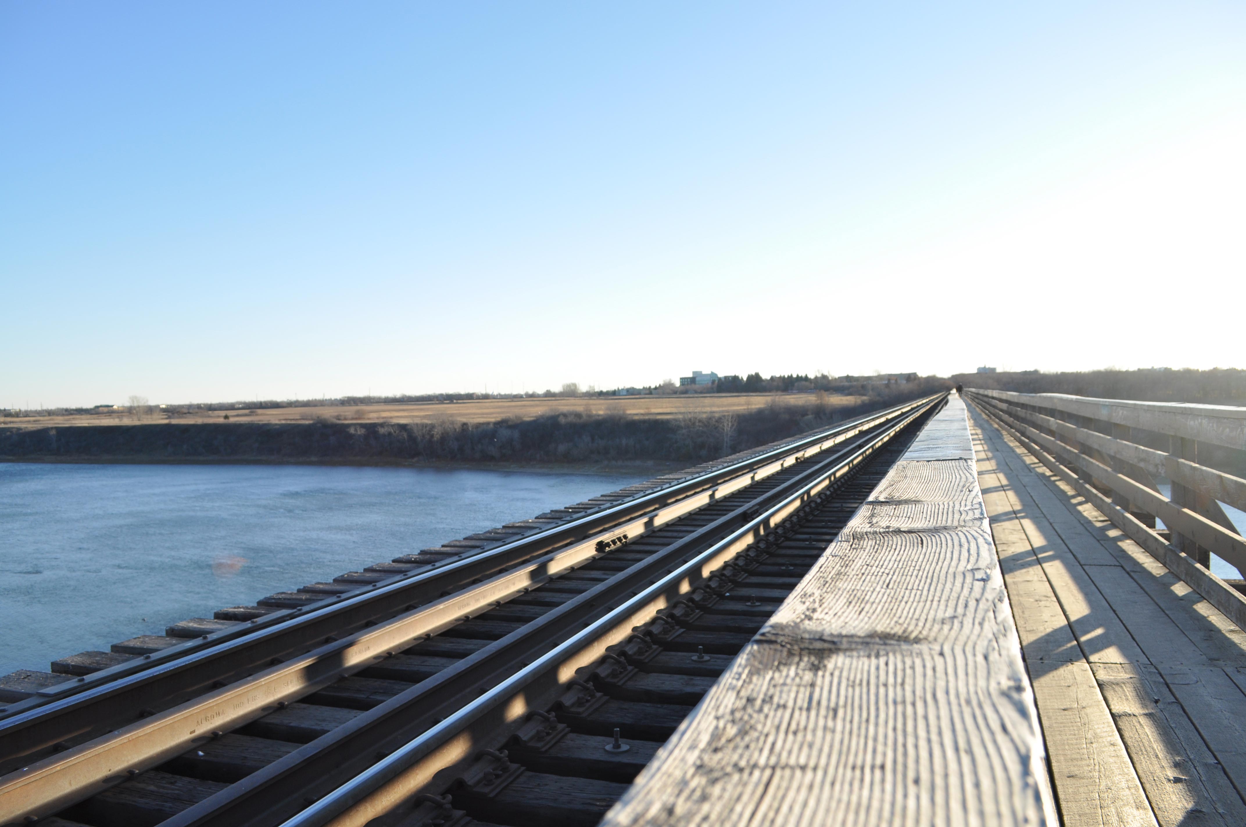 Train bridge leading to an open field